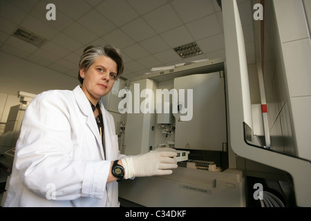 Laboratory worker next to DNA sequencer testing machine Stock Photo
