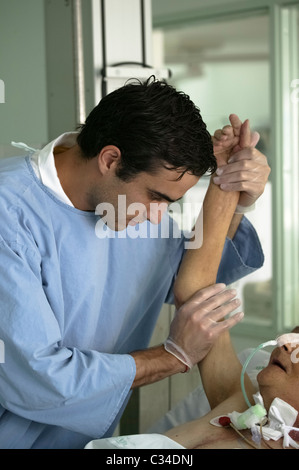 Male nurse taking care of patient in an hospital Stock Photo