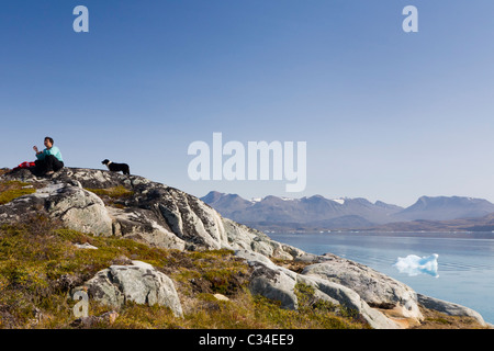 Woman taking a break from berry picking, South Greenland. Stock Photo