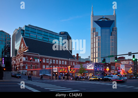 The AT&T building towers over the Ryman Auditorium, historic bars and honky-tonks along Broadway in Nashville Tennessee USA Stock Photo