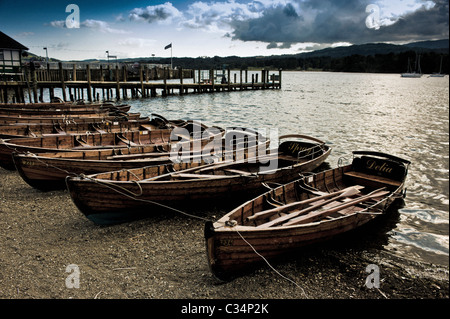 Rowing boats tied up on the shore of lake Windermere, Cumbria. Stock Photo