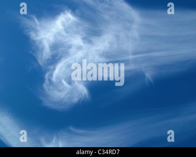 cirrus clouds in a blue sky - high level clouds signifying a possible warm weather front Stock Photo