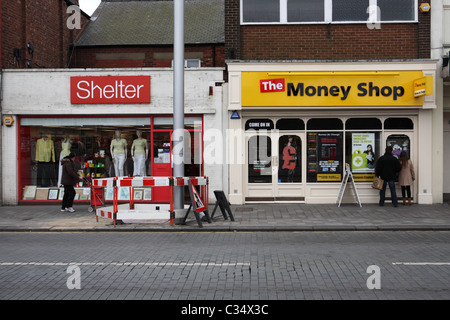 A Shelter charity shop and a pawn broker's or Money Shop in Blyth, north east england, UK Stock Photo