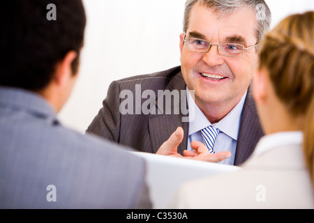 Image of senior leader communicating with his workers Stock Photo