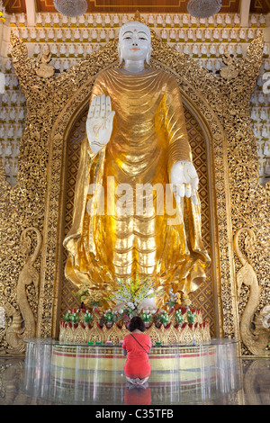 Dhammikarama Burmese Temple in Penang, Malaysia- praying to giant Buddha Stock Photo