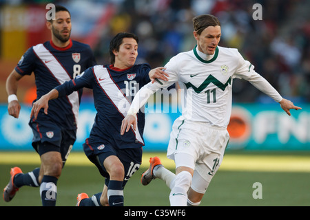 Milivoje Novakovic of Slovenia (11) in action under pressure from Francisco Torres of the USA (16) during a FIFA World Cup match Stock Photo