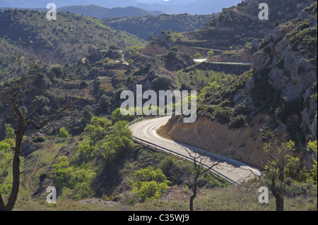 Curved road at Vilanova de Prades Spain through dry hills Stock Photo