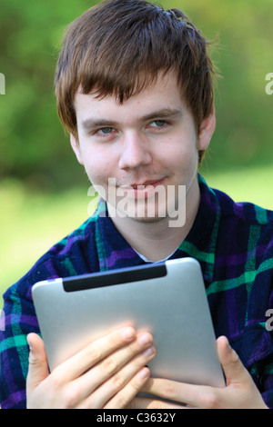 Happy young man holding an ipad Stock Photo