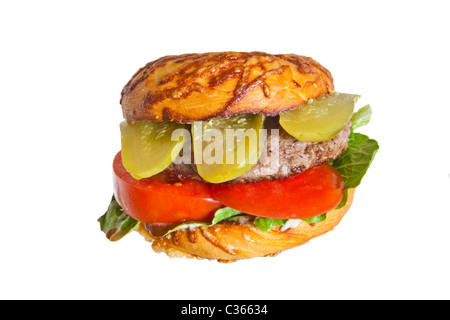 A hamburger on a cheese bagel with lettuce tomato and dill pickle Stock Photo