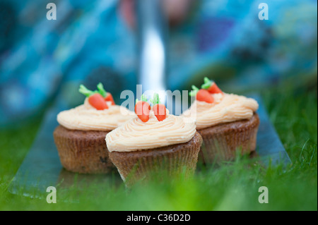 Carrot cupcakes on garden spade selective focus