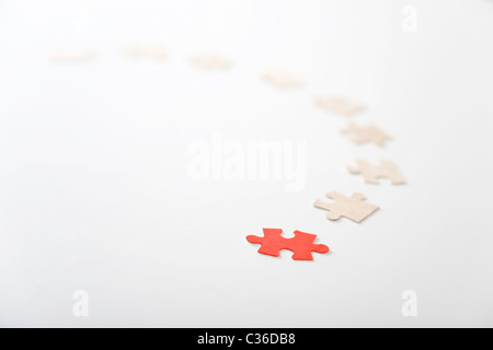 A red puzzle piece on white background, leader metaphor Stock Photo