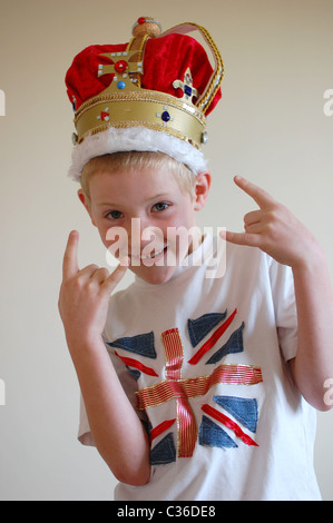 Young boy wearing home made crown and Union Flag t-shirt in a 'cool' pose. Stock Photo