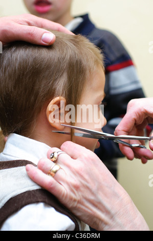 Shalev, Young Jewish boy of three having his first ritual haircut called Upsherin (Yiddish: lit. 'shear off') or Chalaka Stock Photo