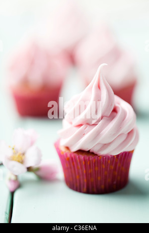 a freshly made creamy, pastel pink cupcake Stock Photo