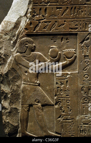 Egyptian Art. Stela of King Intef II Wahankh. Pharaoh offering milk and beer to Ra and Hathor. First Intermediate Period. Stock Photo