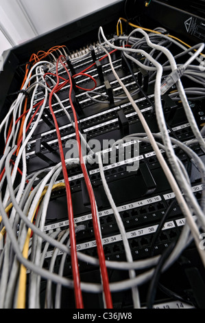 Low angle shot of network switch full of ethernet cables in server room Stock Photo