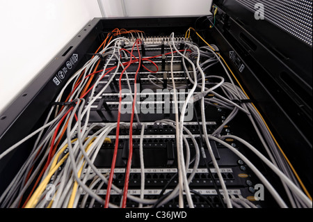Low angle shot of network switch full of ethernet cables in server room Stock Photo