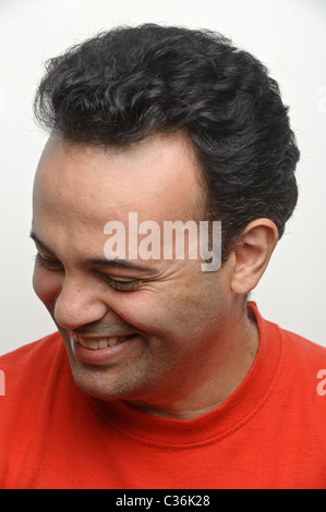 Portrait of a shy smiling man looking away Stock Photo