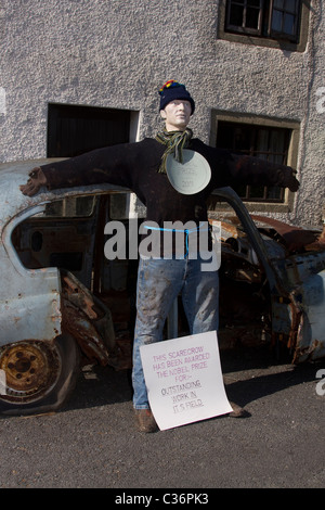 Old rusty banger car  A uninsured wreck parked at the side of the road, Wray Annual Scarecrow Village Festival, Lancaster, Lancashire Stock Photo