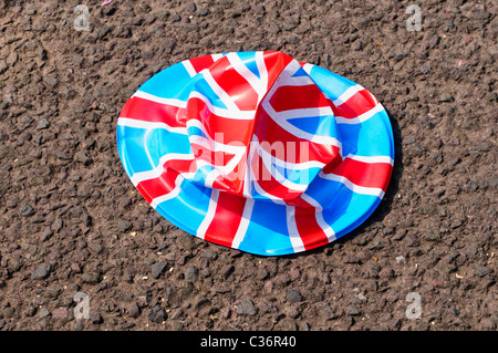 Crushed Union Jack bowler hat lying on the road Stock Photo