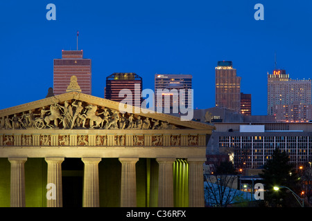 Parthenon replica at twilight with modern buildings of Nashville Tennessee in the background, USA