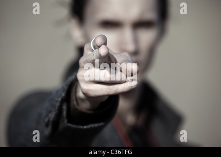 Close-up photo of the criminal man pointing finger. Focus on the fingertip Stock Photo
