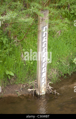 Water level marker on bank of River Bollin, near Manchester Airport Stock Photo