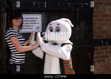 Please wash your hands sign  People at the Petting Farm at Tatton Park, Manchester UK   Mascot Rabbit figure greeting visitors. Stock Photo