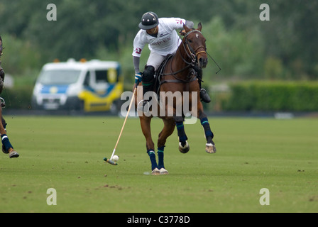 Polo player knocking  ball during match Stock Photo
