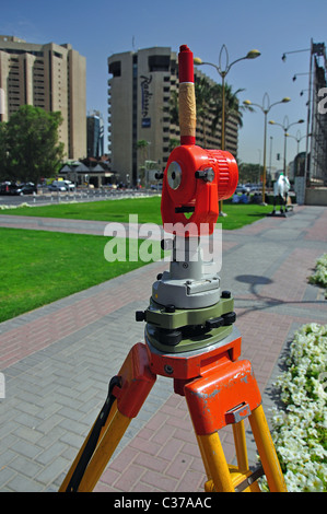 Surveyor's leveling instrument on promenade, Dubai Creek, Deira, Dubai, United Arab Emirates Stock Photo