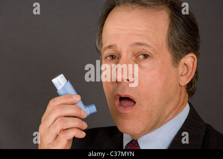 Portrait of Man using an Inhaler Stock Photo