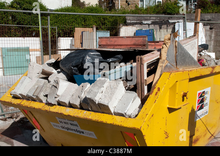 A builders skip full of old building materials Stock Photo