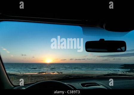 view of the sun setting from inside the car El Cotillo Fuerteventura Canary Islands Stock Photo