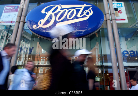 People walking past a Boots store on Oxford Street, London. Stock Photo