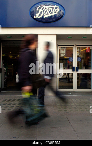 People walking past a Boots store on Oxford Street, London. Stock Photo