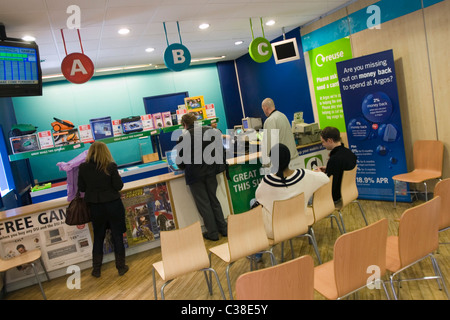 Argos customers waiting to collect their purchases. Part of the home Retail Group. Stock Photo