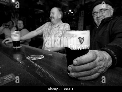 Customers enjoy Guinness in Hells Kitchen Pub, Castlerea, County Roscommon, Ireland. Stock Photo