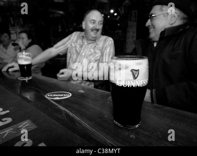 Customers enjoy Guinness in Hells Kitchen Pub, Castlerea, County Roscommon, Ireland. Stock Photo