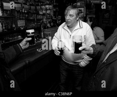 Customers enjoy Guinness in Hells Kitchen Pub, Castlerea, County Roscommon, Ireland. Stock Photo