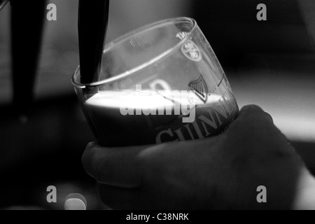 A pint of Guinness being pulled in Sissy McGintys Pub, Castlerea, County Roscommon, Ireland. Stock Photo