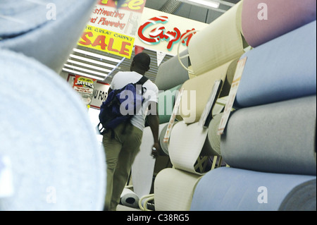 A Carpetright customer walking through a store. Stock Photo