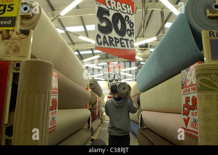 Carpet Right: A Customer carrying his purchase through a Carpet Right store Stock Photo