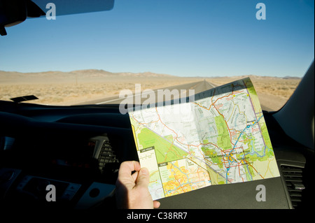 Lost & Reading Map While Driving Through The Desert, Nevada USA Stock Photo
