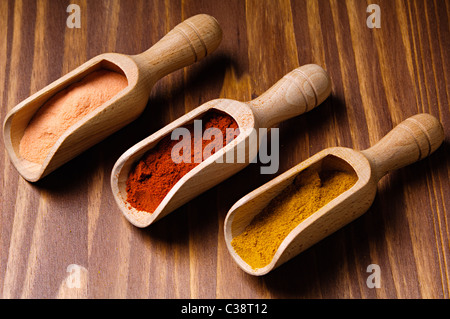 mixed spices in wood spoons, paprika, curry, saffron Stock Photo