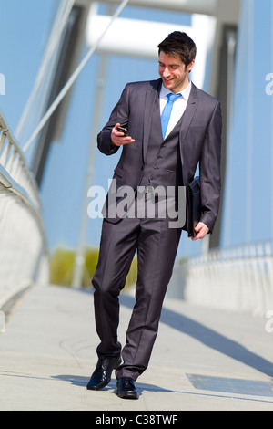 Man walking with mobile phone Stock Photo