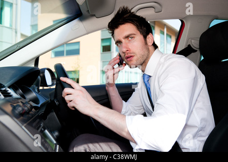 Man talking on phone in car Stock Photo