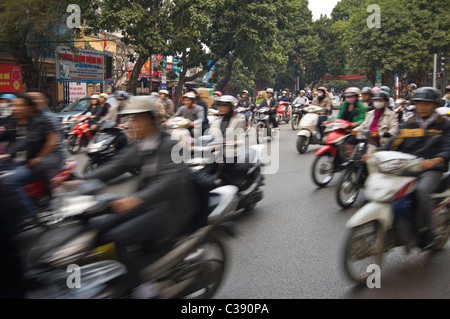 Horizontal wide angle of disorganised chaos on the streets of Hanoi with mopeds, motorbikes & underbones everywhere at rush hour Stock Photo