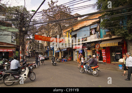 Horizontal wide angle of disorganised chaos on the streets of Hanoi with mopeds, motorbikes & scooters everywhere at rush hour. Stock Photo