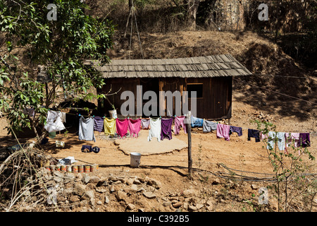 Wooden shack with bright colored clothes drying on line Copala Mexico No release required person unrecognizable Stock Photo