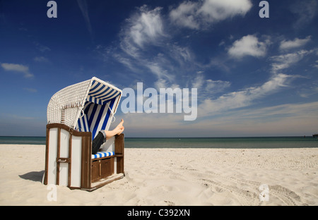 Beach chair with woman on the beach Stock Photo
